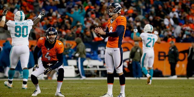 Miami Dolphins quarterback Ryan Tannehill (17) warms up prior to an NFL football game against the Denver Broncos, Sunday, Nov. 23, 2014, in Denver. (AP Photo/Joe Mahoney)