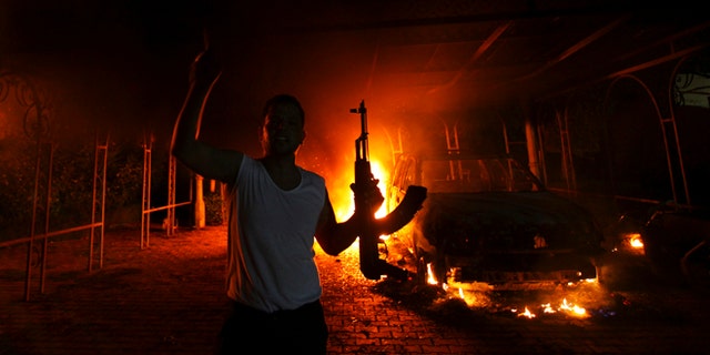 Sept. 11, 2012: A protester reacts as the U.S. Consulate in Benghazi is seen in flames.