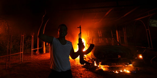 Sept. 11, 2012: A protester reacts as the U.S. Consulate in Benghazi is seen in flames.