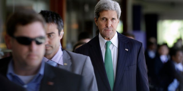 U.S. State Secretary John Kerry walks with other delegate members during the Asia-Pacific Economic Cooperation (APEC) ministerial meeting in Bali, Indonesia, Saturday, Oct. 5, 2013. Kerry says talks on a trans-Pacific trade pact are forging ahead despite President Barack Obama's absence due to the government shutdown. (AP Photo/Dita Alangkara)