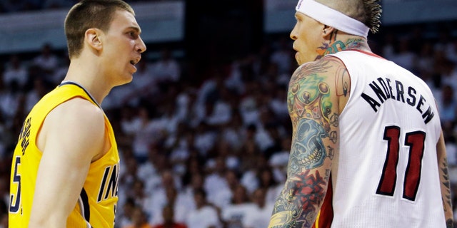 Indiana Pacers forward Tyler Hansbrough (50) exchanges words with Miami Heat forward Chris Andersen (11) during the first half of Game 1 in their NBA basketball Eastern Conference finals playoff series, Wednesday, May 22, 2013 in Miami. Andersen was charged with a technical foul. (AP Photo/Lynne Sladky)
