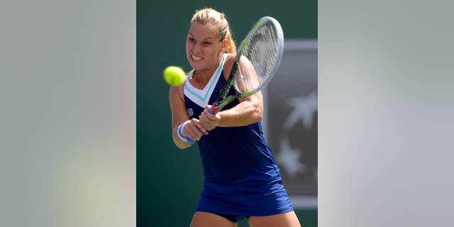 Dominika Cibulkova, of Slovakia, returns a shot to Li Na, of China, during a quarterfinal match at the BNP Paribas Open tennis tournament, Thursday, March 13, 2014 in Indian Wells, Calif. (AP Photo/Mark J. Terrill)