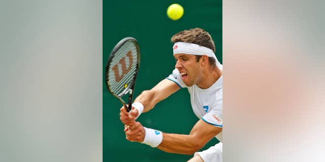 Jiri Vesely of the Czech Republic plays a return to Gael Monfils of France during their men's singles match at the All England Lawn Tennis Championships in Wimbledon, London, Thursday, June 26, 2014. (AP Photo/Sang Tan)