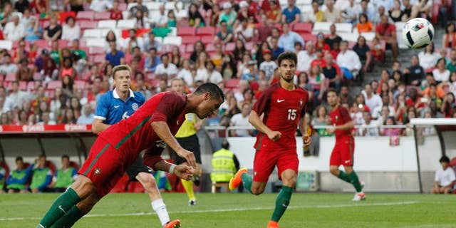 FILE - In this June 8, 2016, file photo, Portugal's Cristiano Ronaldo heads the ball to score against Estonia during a friendly soccer match in Lisbon, Portugal. American soccer fans can watch a quintuple-header of major international tournament matches Saturday, the first of six in the next week-and-a-half.  (AP Photo/Steven Governo, File)
