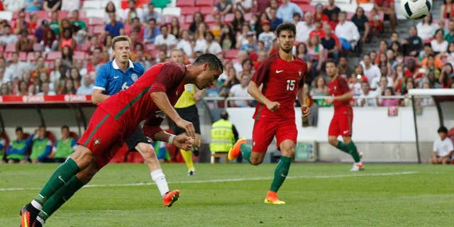 FILE - In this June 8, 2016, file photo, Portugal's Cristiano Ronaldo heads the ball to score against Estonia during a friendly soccer match in Lisbon, Portugal. American soccer fans can watch a quintuple-header of major international tournament matches Saturday, the first of six in the next week-and-a-half. (AP Photo/Steven Governo, File)