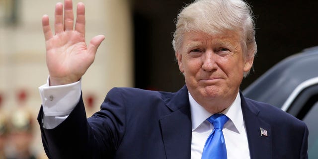 US President Donald Trump waves as he arrives for a meeting with French President Emmanuel Macron at the Elysee Palace in Paris, Thursday, July 13, 2017.