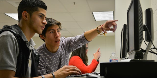 ARLINGTON, VA - JANUARY 23:
Rommel Romano, L, a Washington Lee High School student, gets help writing his college essay from volunteer Rodrigo Ventiades as high school students who are undocumented immigrants receive help writing college essays and scholarship applications from volunteer mentors at Washington Lee High School on Thursday, January 23, 2014, in Arlington, VA. The Dream Project is an Arlington-based organization that provide mentoring and scholarships to undocumented high school graduates who want to attend college but in many states - including Virginia - do not qualify for in-state tuition. Ventiades is from Bolivia and Romano is half Dominican Republican/half Salvadorian.
(Photo by Jahi Chikwendiu/The Washington Post via Getty Images)