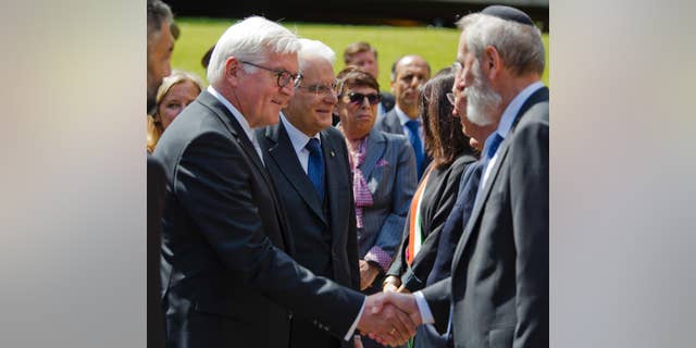German President Frank-Walter Steinmeier, left, flanked by his Italian counterpart Sergio Mattarella, shakes hands with Rome's Chief Rabbi Riccardo Di Segni during a visit to the Fosse Ardeatine Memorial Cemetery in Rome, built on the site of a mass killing of 365 civilians during World War II by the occupying Nazis as a reprisal for a partisan attack the previous day, Wednesday, May 3, 2017. (AP Photo/Domenico Stinellis)