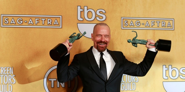Bryan Cranston poses backstage with his awards for outstanding male actor in a drama series for "Breaking Bad" and for outstanding cast in a motion picture for "Argo" at the 19th annual Screen Actors Guild Awards in Los Angeles, California January 27, 2013.