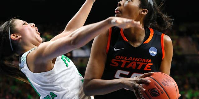 Oklahoma State center LaShawn Jones (55) drives against Notre Dame forward Natalie Achonwa (11) during the second half of of a regional semifinal in the NCAA college basketball tournament at the Purcell Pavilion in South Bend, Ind., Saturday, March 29, 2014. (AP Photo/Paul Sancya)