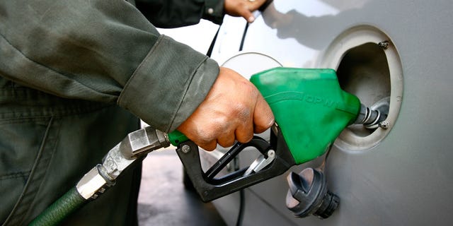 TIJUANA, MEXICO - JUNE 27: A Pemex gas station attendant fills a car registered with a California license plate on June 27, 2008 in Tijuana, Mexico. With the cost of gasoline in California around $4.60 per gallon, many drivers are buying their fuel in Mexico for about $3.20. There is a price to pay for cheaper gas though. Mexican gas is formulated with more sulfur than California gas and that can damage the emission control equipment on US cars, causing them to fail emissions tests and leading to expensive repairs. In addition, unless a driver has other business in Mexico, part of their fuel savings will be burned up idling in a line that can easily last for hours to get back into the US. (Photo by David McNew/Getty Images)