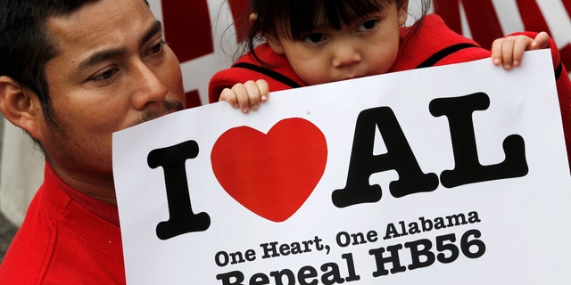 Opponents of Alabama's immigration law gather for a rally outside the Statehouse in Montgomery, Ala., on Tuesday, Feb. 14, 2012. Â The group was calling for the repeal of HB56 which is considered to be among the strongest immigration laws in the country. (AP Photo/Dave Martin)