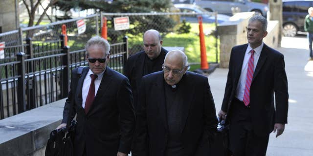 FILE - In this Thursday, April 14, 2016 file photo, attorneys lead Franciscans Giles Schinelli, front, and Anthony Criscitelli to their hearing at the Blair County courthouse in Hollidaysburg, Pa. Testimony is set to resume in the case of three Franciscan friars charged with allowing a suspected sexual predator to teach at a Pennsylvania high school and hold other jobs where he molested more than 100 children. A preliminary hearing on Wednesday, April 27, 2016, will determine whether Schinelli, Robert D'Aversa and Criscitelli will stand trial on child endangerment and conspiracy charges. (Todd Berkey/The Tribune-Democrat via AP, File) MANDATORY CREDIT