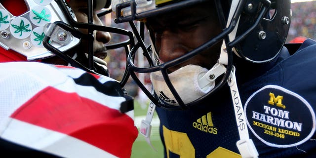 Michigans' Devin Gardner is comforted by Ohio States' Braxton Miller after Michigan's 42-41 loss in an NCAA college football game Saturday, Nov. 30, 2013 at Michigan Stadium in Ann Arbor, Mich. (AP Photo/Detroit Free Press, Kirthmon F. Dozier) DETROIT NEWS OUT; NO SALES, MANDATORY CREDIT
