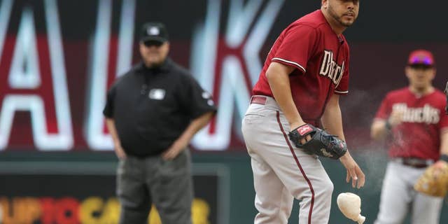 Arizona Diamondbacks' pitcher Vidal Nuno looks on after giving up a walk to Minnesota Twins' Kennys Vargas in the first inning of a baseball game, Wednesday, Sept. 24, 2014, in Minneapolis. Nuno gave up three walks in the first. (AP Photo/Jim Mone)