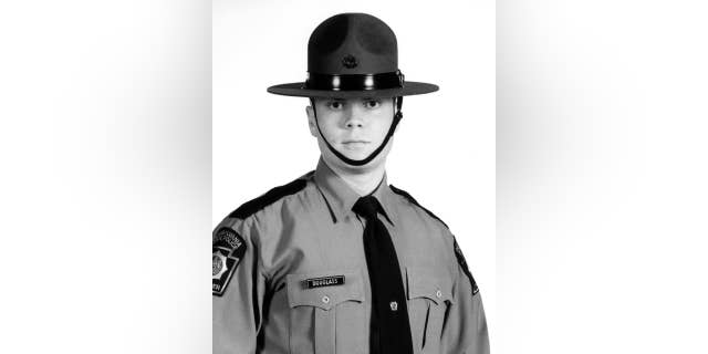 FILE - This undated file photo provided by the Pennsylvania State Police shows Trooper Alex Douglass. Douglass, wounded in the Sept. 12 shooting outside the Blooming Grove barracks that killed Cpl. Bryon Dickson, made his first public remarks Saturday, March 28, 2015, as the borough of Dunmore named a road after Dickson. Douglass, who walked with a cane, told reporters he feels good and no longer needs crutches to get around. He says he has had 16 surgeries with one more scheduled next month. (AP Photo/Pennsylvania State Police, File)