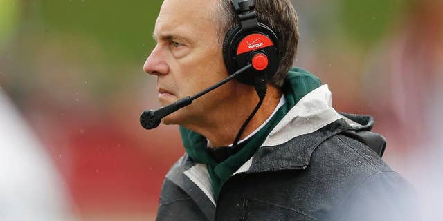 Michigan State head coach Mark Dantonio watches his team during the first half of an NCAA college football game in Bloomington, Ind., Saturday, Oct. 18, 2014. Michigan State won the game 56-17. (AP Photo/Sam Riche)