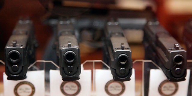 FILE: Handguns are displayed.