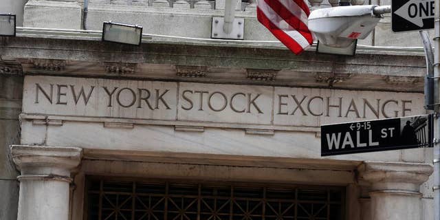 FILE - This Oct. 2, 2014 file photo shows the Wall Street entrance of the New York Stock Exchange, in New York. U.S. stocks opened lower Wednesday, April 29, 2015, as the economy skidded to a near halt in the first three months of the year after being battered by harsh weather, plunging exports and sharp cutbacks in oil and gas drilling. (AP Photo/Richard Drew, File)