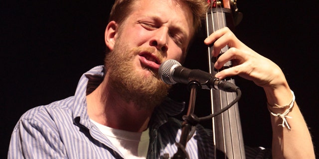 This Feb. 16, 2013 file photo shows Ted Dwane, of the English folk rock band Mumford & Sons, performing at the Susquehanna Bank Center in Camden, N.J. Dwane has a blood clot on his brain that will require surgery.