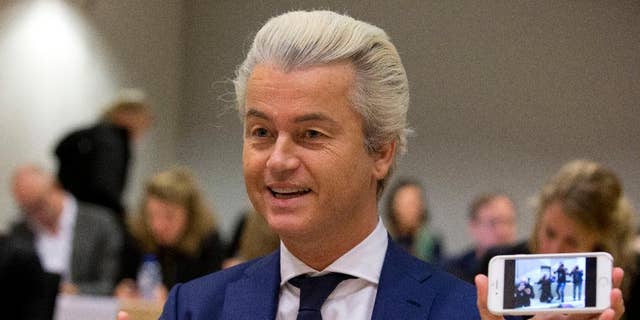 In this Friday March 18, 2016 file photo Populist anti-Islam lawmaker Geert Wilders shows a picture he took of the photographers as he appeared in court for a pretrial hearing at a high-security court on charges of inciting hatred, in Amsterdam, Netherlands. Wilders was in court Friday Sept. 23 for a pre-trial hearing in his hate speech prosecution. (AP Photo/Peter Dejong)