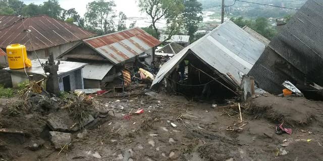 Houses are seen buried under the mud following a landslide in Songan village on Bali island, Indonesia, Friday, Feb. 10, 2017. A number of people including young children were killed in the landslides on the tourist island that wiped out several homes, Indonesia's disaster mitigation agency said. (AP Photo)