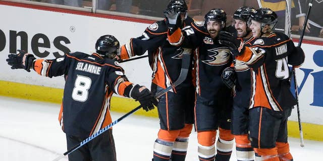 Members of the Anaheim Ducks celebrate Mathieu Perreault's goal during the second period in Game 5 of an NHL hockey second-round Stanley Cup playoff series against the Los Angeles Kings in Anaheim, Calif., Monday, May 12, 2014. (AP Photo/Chris Carlson)