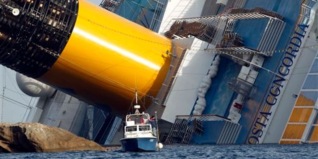 Jan. 22: A police boat sails by the grounded cruise ship Costa Concordia, off the Tuscan island of Giglio, Italy. Rescuers on Sunday resumed searching the above-water section of the capsized Costa Concordia cruise liner, but choppy seas kept divers from exploring the submerged part, where officials have said there could be bodies.