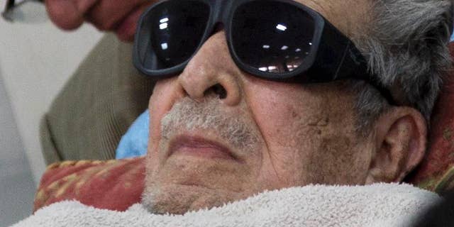 FILE - In this Jan. 5, 2015 file photo, Guatemala's former dictator Jose Efrain Rios Montt arrives on a gurney wearing sunglasses to court where he faces charges of genocide and crimes against humanity in Guatemala City. A Guatemalan court ordered on Thursday, July 23, 2015, Rios Montt be put in a psychiatric hospital for nine days’ observation, delaying his possible retrial on genocide charges. The court order seeks to evaluate the 89-year-old ex-general's mental and physical health following a report that found him incompetent to stand trial. (AP Photo/Luis Soto, File)