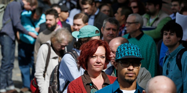 Job seekers line up to attend a job fair in Downtown Denver.