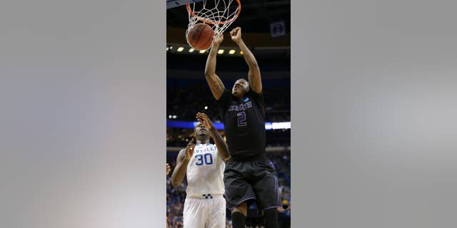 Kansas State's Marcus Foster (2) gets past Kentucky's Julius Randle (30) to dunk the ball during the first half of a second-round game in the NCAA college basketball tournament, Friday, March 21, 2014, in St. Louis. (AP Photo/Charlie Riedel)