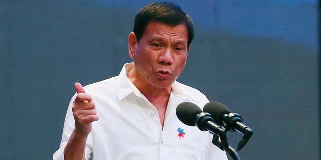 FILE - In this Thursday, Oct. 13, 2016, file photo, Philippine President Rodrigo Duterte gestures during his address to a Filipino business sector in suburban Pasay city, south of Manila, Philippines. Duterte acknowledged Sunday, Oct. 16, 2016, that he can be impeached if he concedes the country's territorial claims in the South China Sea in upcoming talks with Chinese President Xi Jinping and other Chinese leaders in Beijing. (AP Photo/Bullit Marquez, File)