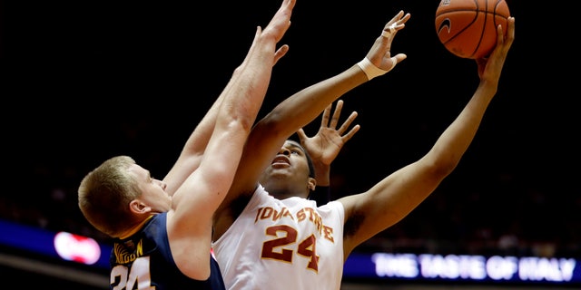 Iowa State center Percy Gibson (24) shoots over West Virginia forward Kevin Noreen during the first half of an NCAA college basketball game, Wednesday, Jan. 16, 2013, in Ames, Iowa. (AP Photo/Charlie Neibergall)