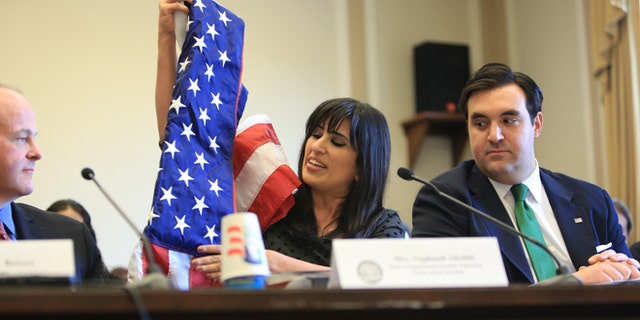 Naghmeh Abedini, wife of imprisoned American pastor Saeed Abedini, displays a U.S. flag her husband received when he became a U.S. citizen in this Marc, 2013 file photo.