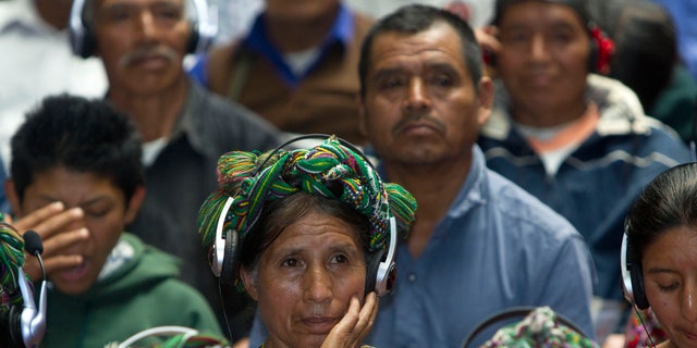 An Ixil Indian woman, the relative of a civil war victim, uses earphones to hear translations between Spanish and the Ixil language during the genocide trial of former dictator Jose Efrain Rios Montt in Guatemala City, Thursday, May 9, 2013.  The 86-year-old ex-general says he never ordered attacks against "a race,"denying he ordered the extermination of Ixil Mayas. Prosecutors say that while in power, Rios Montt was aware of, and thus responsible for, the slaughter of at least 1,771 Ixil Mayas in the towns of San Juan Cotzal, San Gaspar Chajul and Santa Maria Nebaj in Guatemala's western highlands. (AP Photo/Moises Castillo)