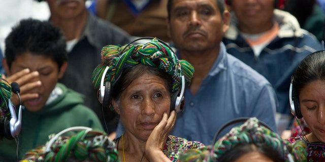 An Ixil Indian woman, the relative of a civil war victim, uses earphones to hear translations between Spanish and the Ixil language during the genocide trial of former dictator Jose Efrain Rios Montt in Guatemala City, Thursday, May 9, 2013. The 86-year-old ex-general says he never ordered attacks against "a race,"denying he ordered the extermination of Ixil Mayas. Prosecutors say that while in power, Rios Montt was aware of, and thus responsible for, the slaughter of at least 1,771 Ixil Mayas in the towns of San Juan Cotzal, San Gaspar Chajul and Santa Maria Nebaj in Guatemala's western highlands. (AP Photo/Moises Castillo)