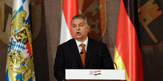 Hungary's Prime Minister Victor Orban stands on the podium during his speech to mark the 60th anniversary of the Hungarian Revolution in Munich, Germany, Monday, Oct. 17, 2016. (AP Photo/Matthias Schrader)