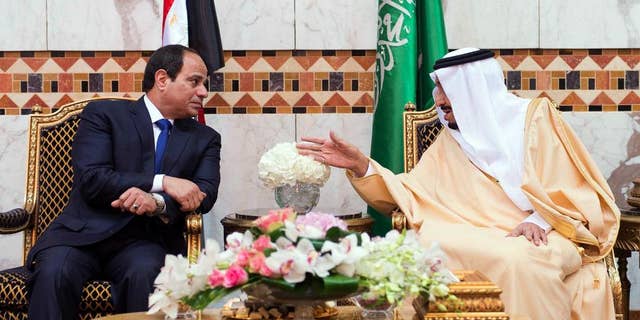 FILE - In this file photo provided by the Saudi Press Agency on March 1, 2015, Saudi King Salman, right, meets with Egyptian President Abdel-Fattah el-Sissi upon his arrival to Riyadh Airbase, Riyadh, Saudi Arabia. Egypt's president says his country remains committed to close relations with its Gulf Arab allies, but will continue to independently pursue its own policies to safeguard Arab security. El-Sissi's comments on Thursday, Oct. 13, 2016 were his first after a diplomatic row erupted this week between Egypt and close ally Saudi Arabia over Syria.(SPA via AP, File)