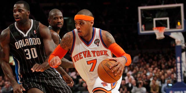 New York Knicks' Carmelo Anthony drives past Orlando Magic's Brandon Bass during the first half of an NBA basketball game on Wednesday, March 23, 2011, in New York. (AP Photo/Frank Franklin II)