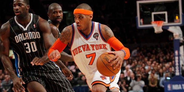 New York Knicks' Carmelo Anthony drives past Orlando Magic's Brandon Bass during the first half of an NBA basketball game on Wednesday, March 23, 2011, in New York. (AP Photo/Frank Franklin II)