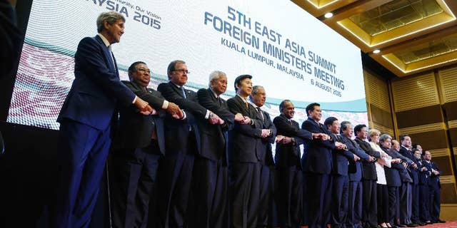 From left to right, U.S. Secretary of State John Kerry, Myanmar's Foreign Minister Wunna Maung Lwin, New Zealand's Foreign Minister Murray McCully, Philippines Secretary of Foreign Affairs Albert del Rosario, South Korea's Foreign Minister Yun Byung-se, Russia's Foreign Minister Sergey Lavrov, Singapore's Foreign Minister K. Shanmugam, Thailand's Foreign Minister Tanasak Patimapragorn, Vietnam's Foreign Minister Pham Binh Minh, Malaysia's Foreign Minister Anifah Aman, Laos's Foreign Minister Thongloun Sisoulith, Australia's Foreign Minister Julie Bishop, Brunei's Foreign Minister Mohamed Bolkiah, Cambodia's Foreign Minister Hor Namhong, China's Foreign Minister Wang Yi, India's Foreign Minister Vijay Kumar Singh, Indonesia's Foreign Minister Retno Marsudi, Japan's Foreign Minister Fumio Kishida and ASEAN's Secretary General Le Luong Minh pose for a photograph before the East Asia Summit Foreign Ministers' Meeting in Kuala Lumpur, Malaysia Thursday, Aug. 6, 2015. (AP Photo/Joshua Paul)