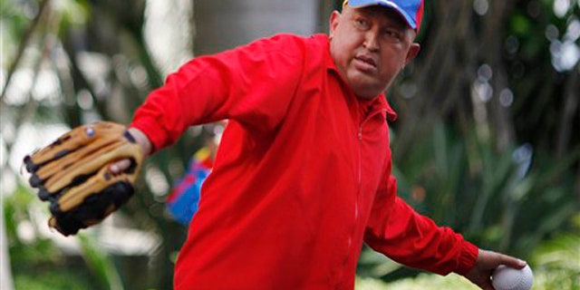 In this photo released by Miraflores Press Office, Venezuela's President Hugo Chavez throws a softball after giving a live address on state TV at Miraflores presidential palace in Caracas, Venezuela, Thursday Sept. 29, 2011.