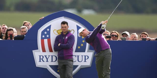 Europe’s Rory McIlroy plays off the 14th tee as Martin Kaymer looks on during a practice round ahead of the Ryder Cup golf tournament at Gleneagles, Scotland, Wednesday, Sept. 24, 2014. (AP Photo/Peter Morrison)