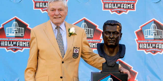 FILE- Int is Aug. 4, 2012, file photo, former NFL football player Jack Butler poses with a bust of himself during an induction ceremony at the Pro Football Hall of Fame in Canton, Ohio. Butler died Saturday morning, may 11, 2013, following a lengthy battle with a staph infection, his son John Butler said. He was 85. (AP Photo/Gene J. Puskar, File)