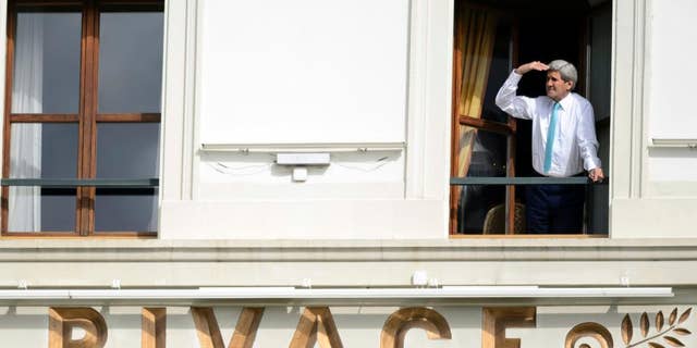 FILE - In this April 1, 2015 file photo US Secretary of State John Kerry looks at the view of Lake Geneva from his hotel room as the Iran nuclear talks continue in Lausanne, Switzerland. Iran left the negotiating table in Lausanne, Switzerland, on Thursday, Aoril 2, 2015 with a commitment to implement the Additional Protocol, IAEA’s most potent monitoring instrument. (AP Photo/Keystone, Laurent Gillieron, file)