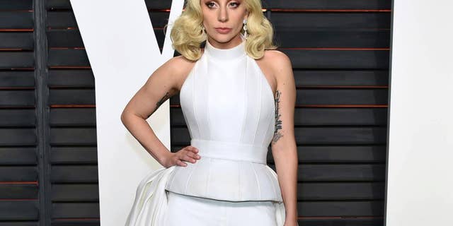 FILE - In this Feb. 28, 2016 file photo, Lady Gaga arrives at the Vanity Fair Oscar Party in Beverly Hills, Calif. Lady Gaga is choosing the intimacy of dive bars over arenas to showcase songs from her new album, "Joanne." She'll appear at a handful of bars beginning this week as a nod to the album's "raw Americana" vibe and where she got her start, Gaga and tour partner Bud Light announced Sunday, Oct. 2, 2016. (Photo by Evan Agostini/Invision/AP, File)