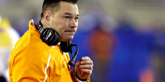 FILE- In this file photo from Nov. 30, 2013, Tennessee first-year coach Butch Jones watches his team against Kentucky in an NCAA college football game in Lexington, Ky. (AP Photo/Garry Jones, File)