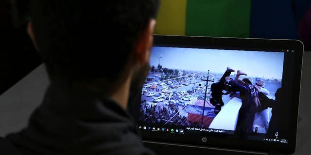 Daniel Halaby, a gay Syrian living in southern Turkey, shows a photo from his laptop of ISIS militants throwing a man off a roof allegedly for violating the extremists' ban on homosexuality.