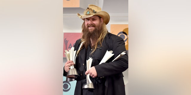 Chris Stapleton poses in the press room with the awards for album of the year for "Traveller", new male vocalist of the year, male vocalist of the year and song of the year for Nobody to Blame, at the 51st annual Academy of Country Music Awards at the MGM Grand Garden Arena on Sunday, April 3, 2016, in Las Vegas.