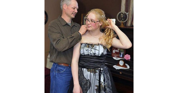 David Herron made a camouflage prom dress for his youngest daughter, Mariah, 17, in Marshfield, Wis.